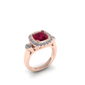 14kt rose gold ring with a cushion-shaped ruby center stone and a halo round round brillinat cut white diamonds, and two bezel set diamonds on either side.