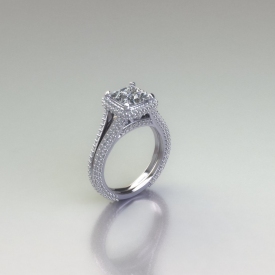 14kt white gold halo style engagement ring with a pave style split shank and halo, there are round brilliant cut diamonds set throughout the ring and the center diamond is a princess cut diamond.