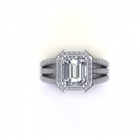 14kt white gold engagement ring with an emerald cut center diamond that has a halo with round brilliant cut diamonds, the shank is three bands with bead set round brilliant cut diamonds connected at the halo.