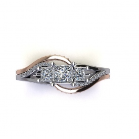 14kt two tone three-stone ring with the center diamonds being three princess cuts, the sides are swirled with white gold and diamonds, and an outer band of high polish rose gold with round diamonds set on the face.